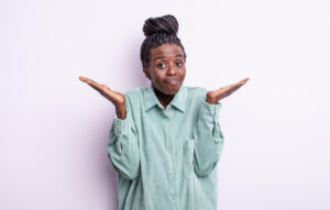 an african woman in a lavender color shirt with asking questions